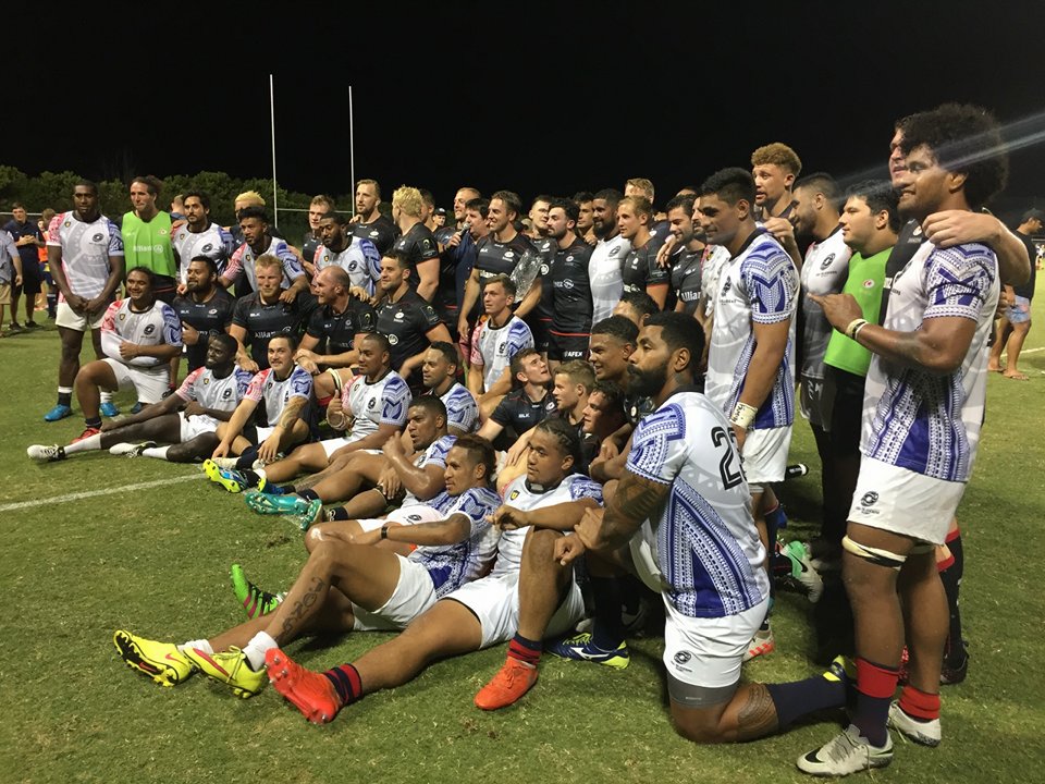 Players gathered on the rugby field for a photo